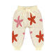 Beige baby pants with starfish patterns on a white background