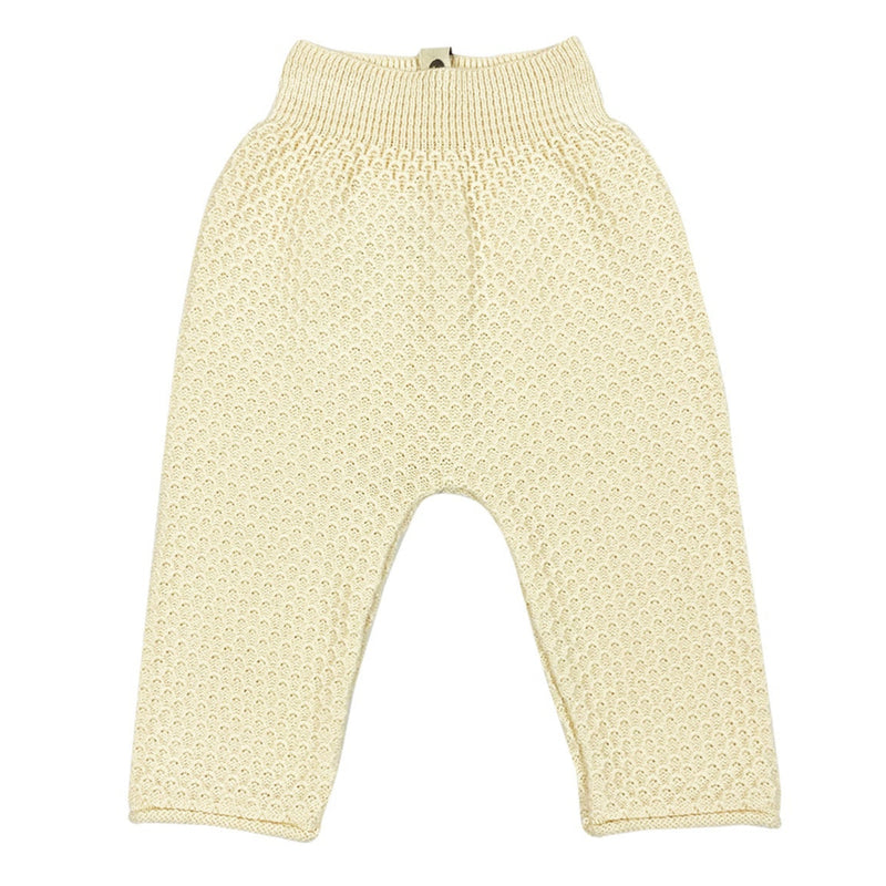 A pair of beige, basket knitted stitch baby pants with an elastic waistband.